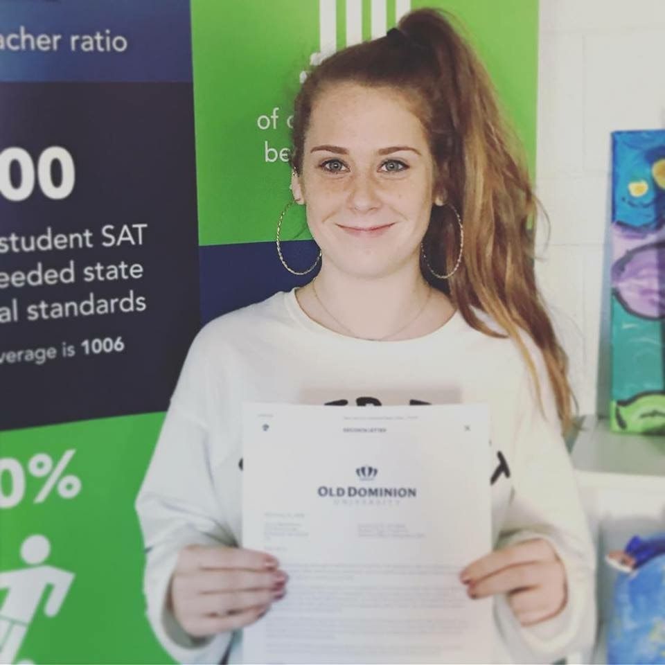 Smiling young student in white shirt with a pony tail 