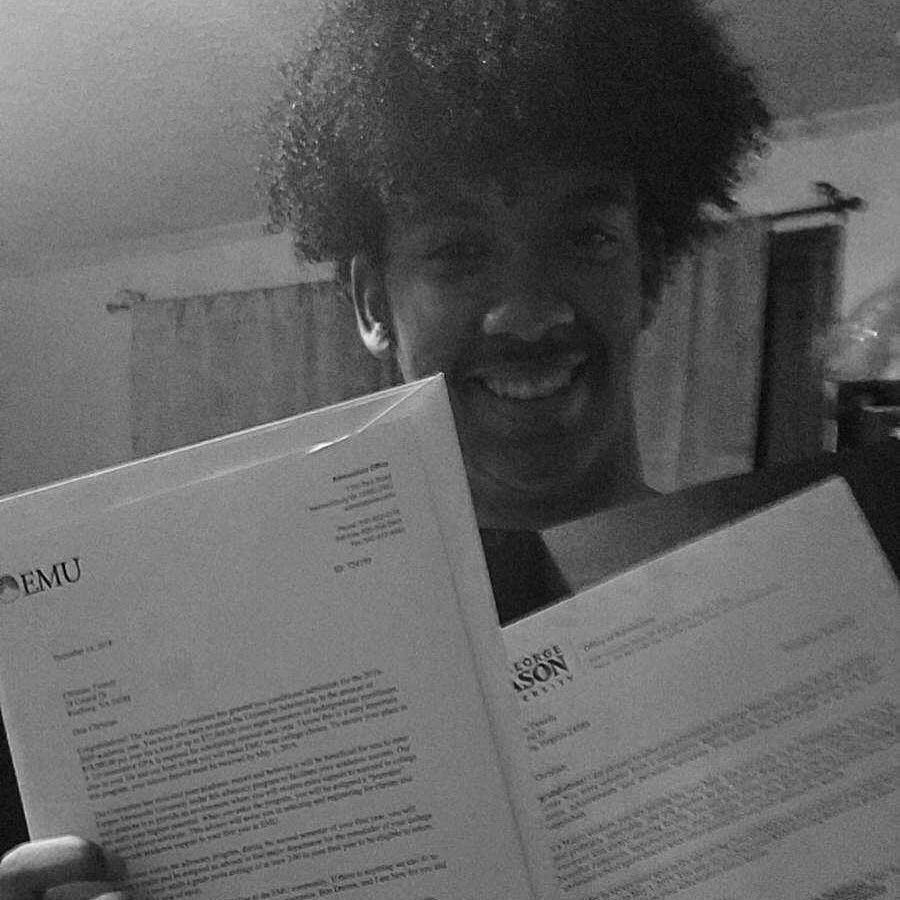 Smiling image of a male holding papers