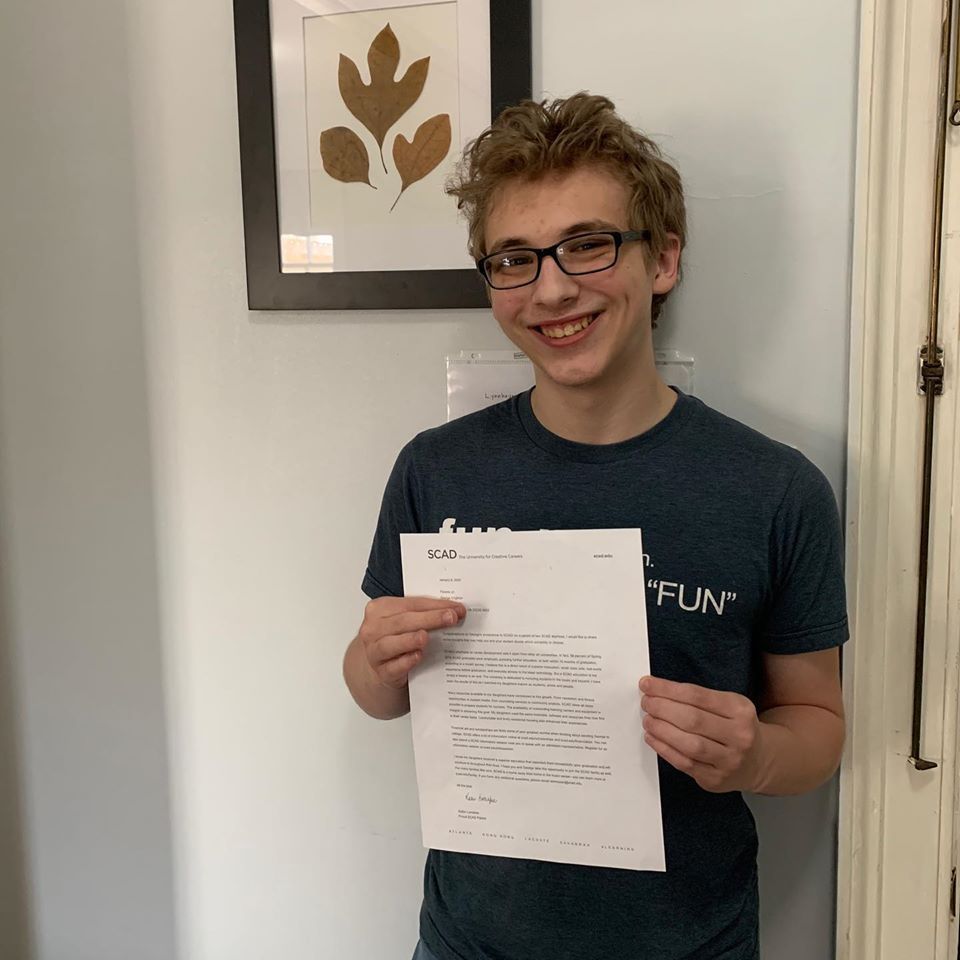 Smiling image of a male holding papers