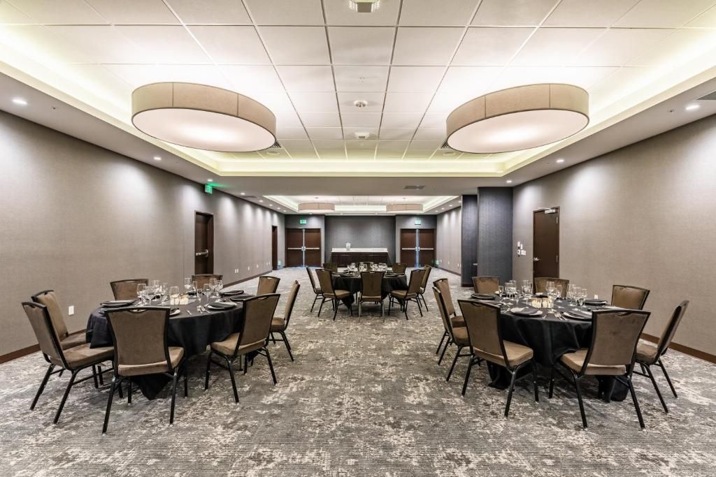 A large room with tables and chairs set up for a banquet.