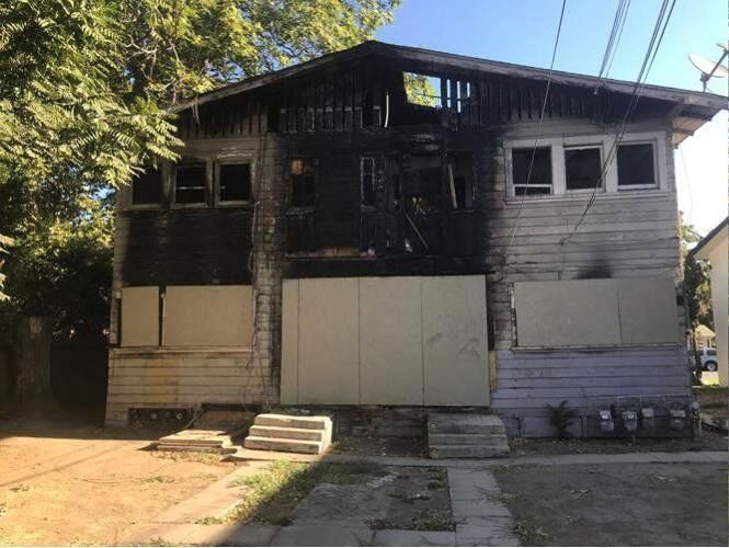 A house with a lot of windows has been damaged by a fire.