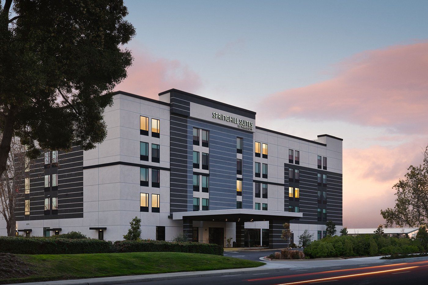 A large building with a sunset in the background