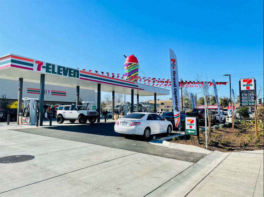 A 7 eleven gas station with cars parked in front of it