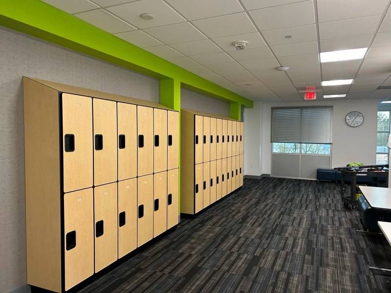A row of wooden lockers are lined up in a room.