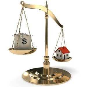scale measuring a house and a bag of money