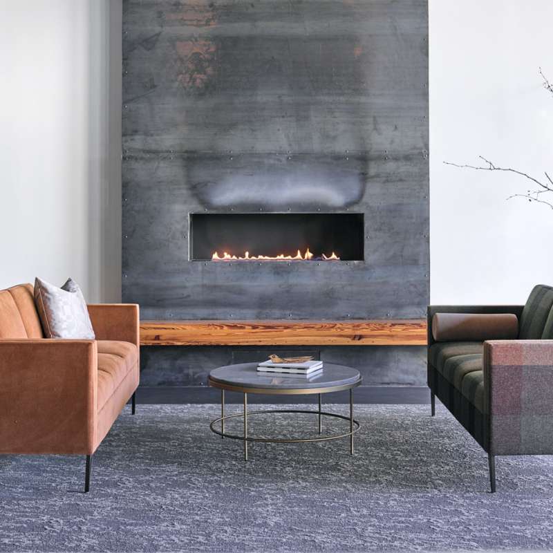 A living room with two couches and a fireplace