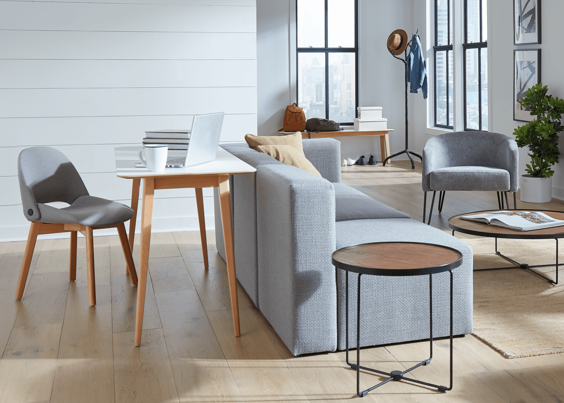 A living room with a couch , chairs , a table and a coffee table.