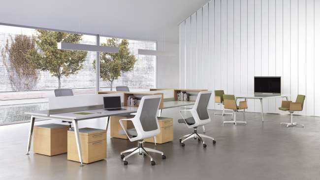 A room with a lot of desks and chairs in it