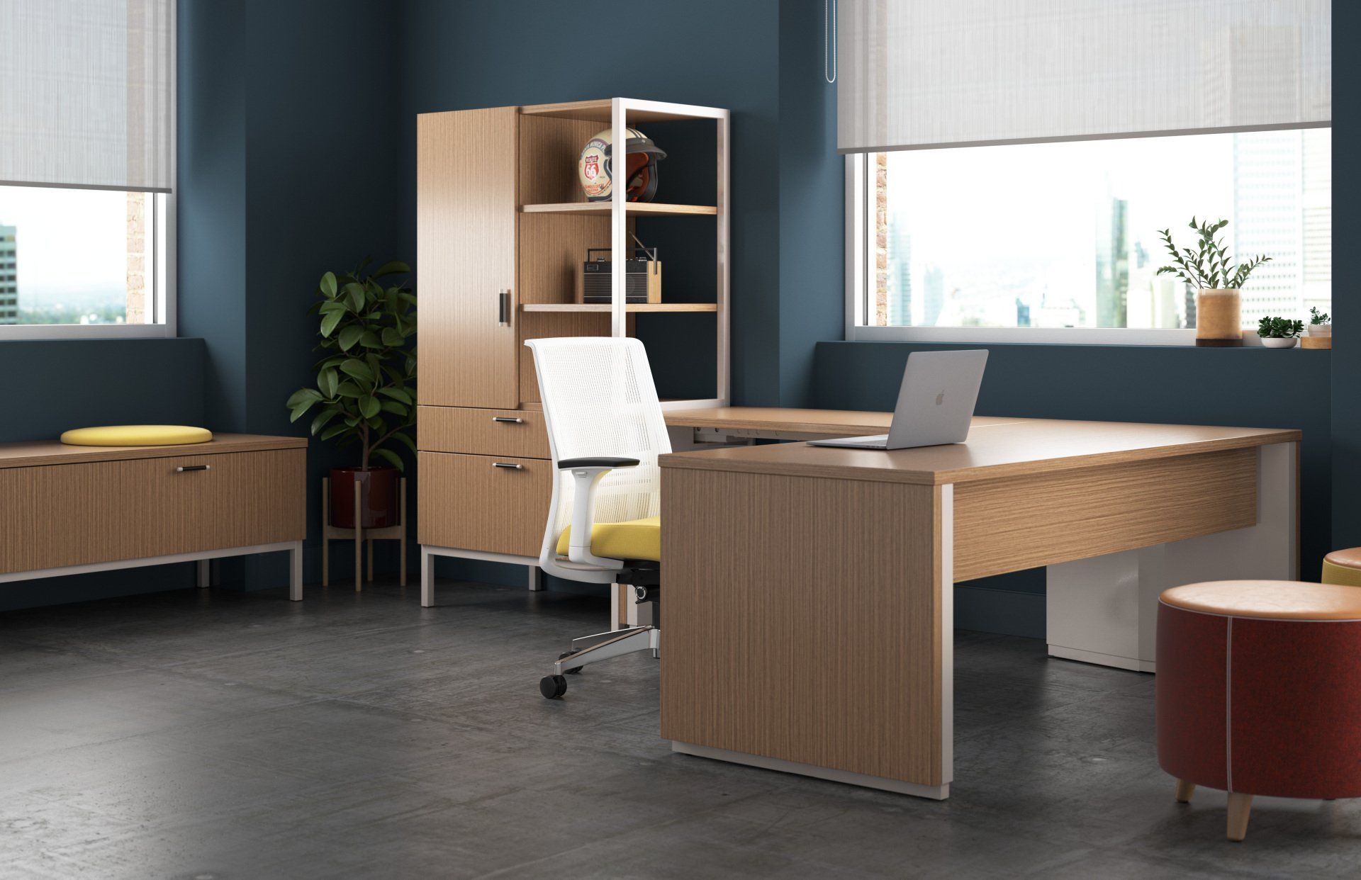 There is a desk with a laptop on it in the middle of the room.