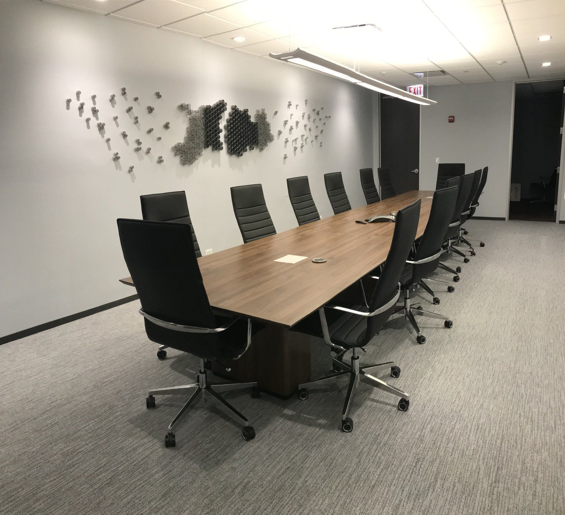 A conference room with a long table and chairs