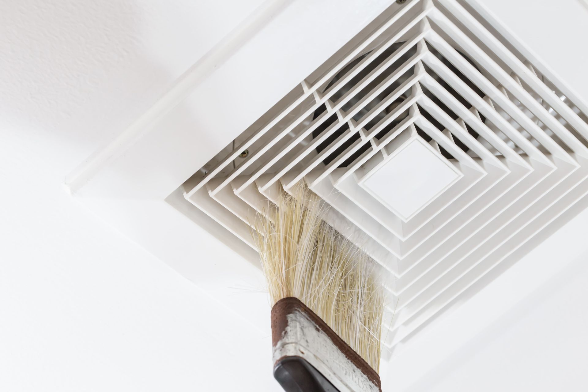 Ceiling vent with a yellowish curtain or fabric hanging down into it