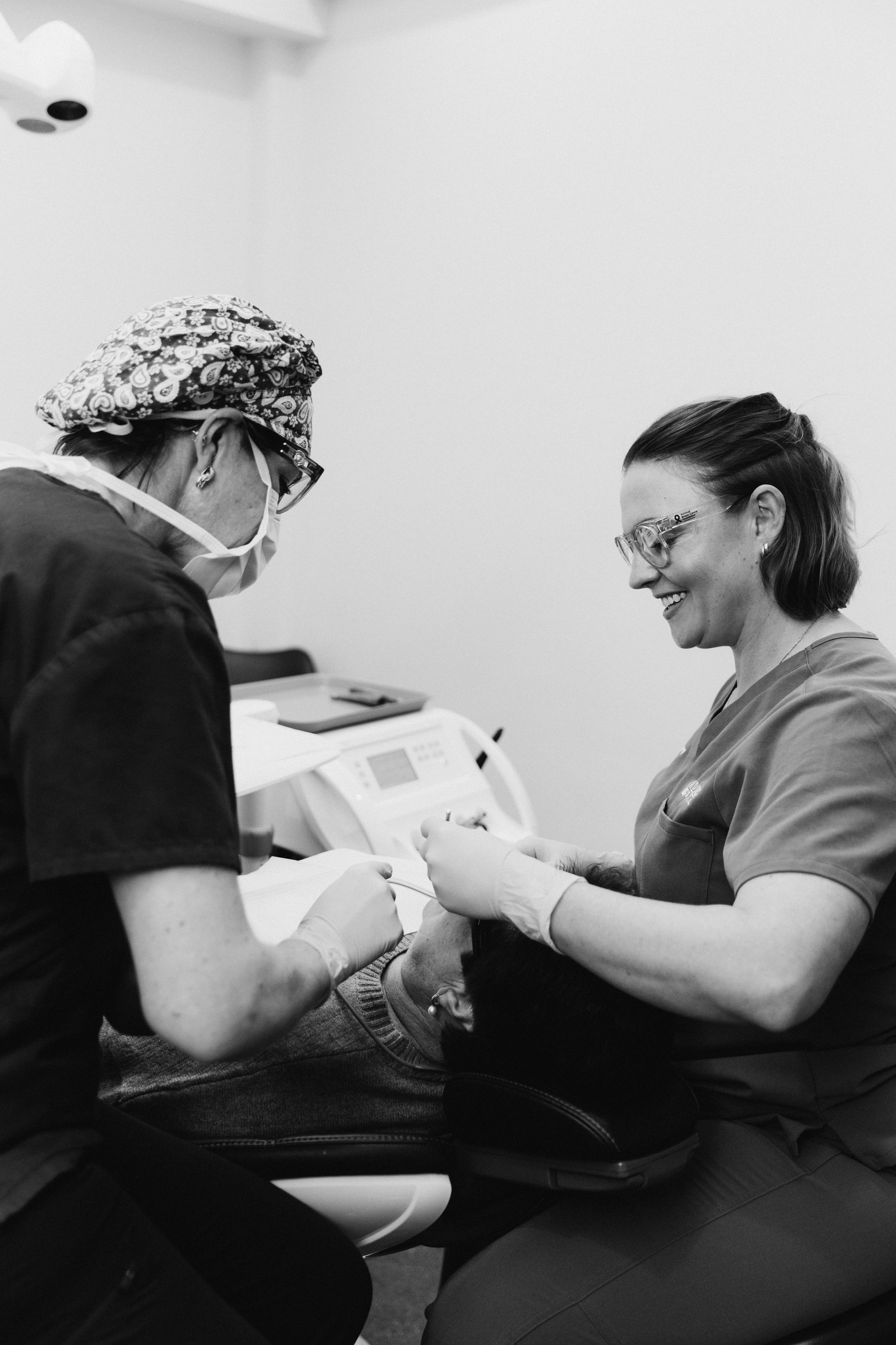 Dentist and Assistant Work on Patient's Mouth in a Dental Office — Dubbo Dental in Dubbo, NSW