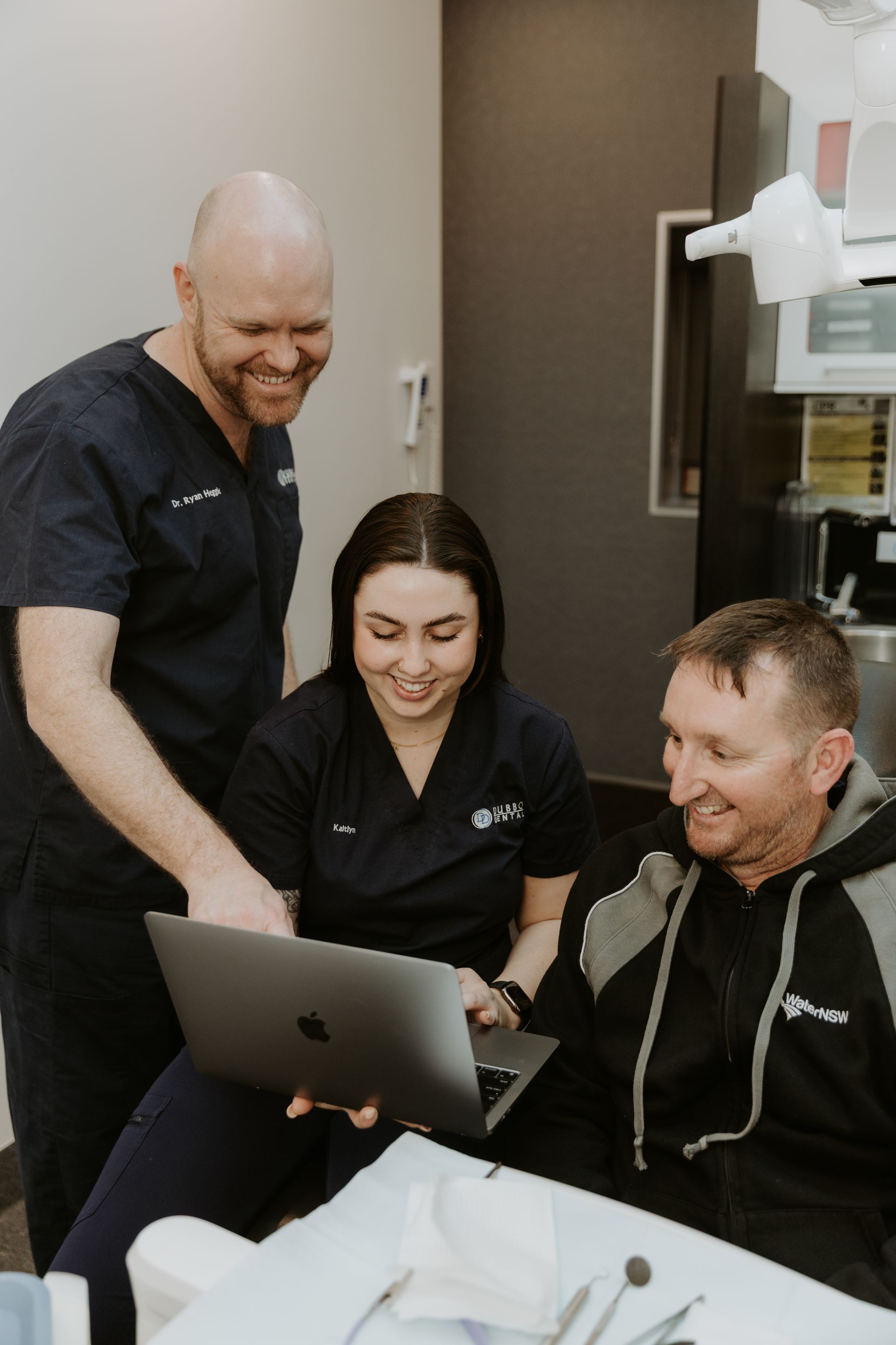 Two Dental Staff Showing a Patient Something on a Laptop in an Exam Room — Dubbo Dental in Dubbo, NSW