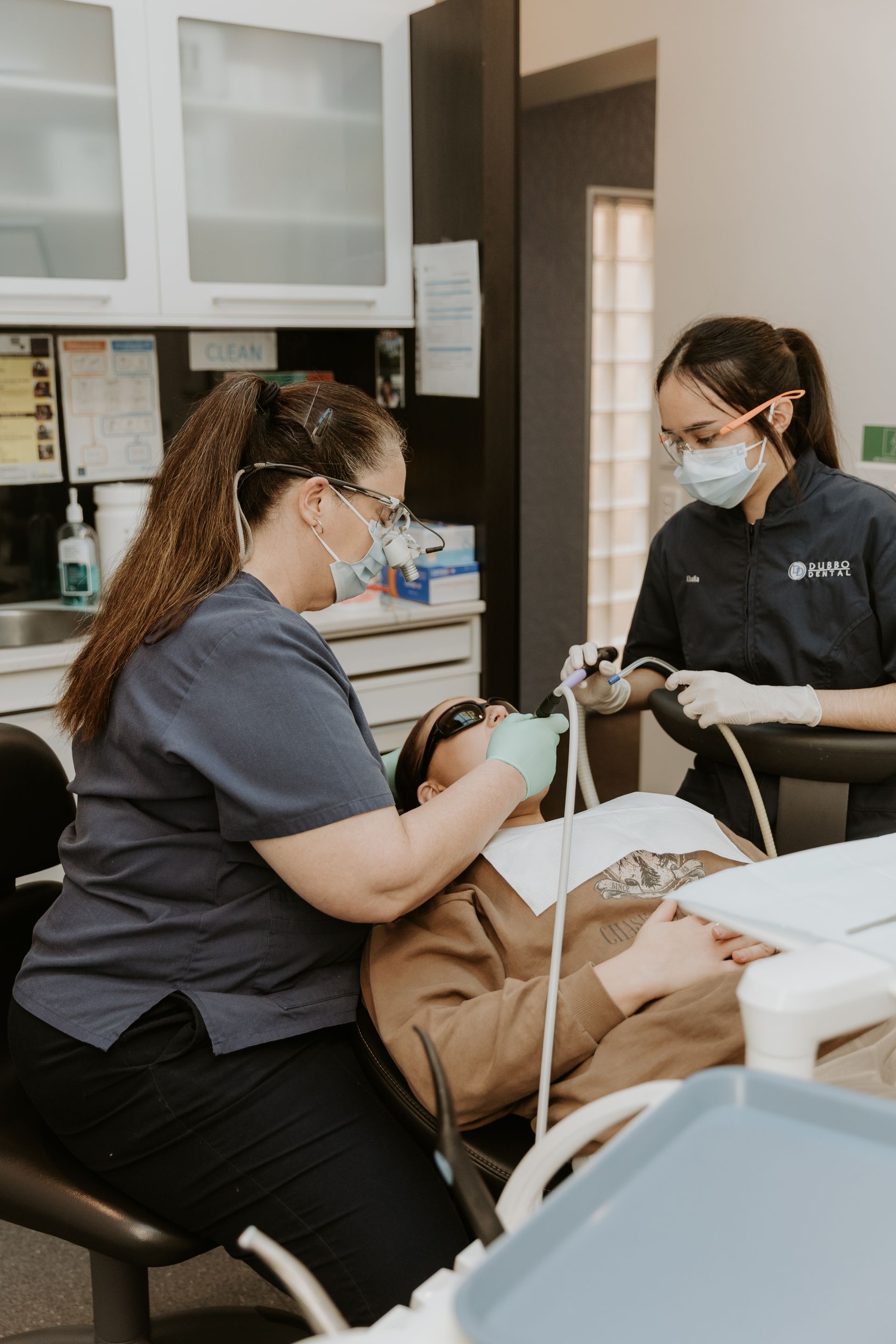 Two Dental Professionals Working on a Patient in a Dental Office — Dubbo Dental in Dubbo, NSW