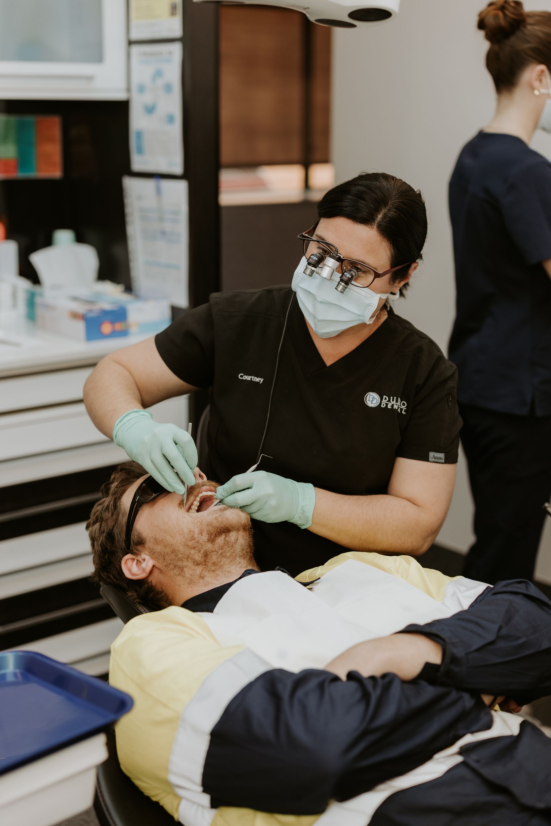 Dentist Working on a Male Patient — Dubbo Dental in Dubbo, NSW