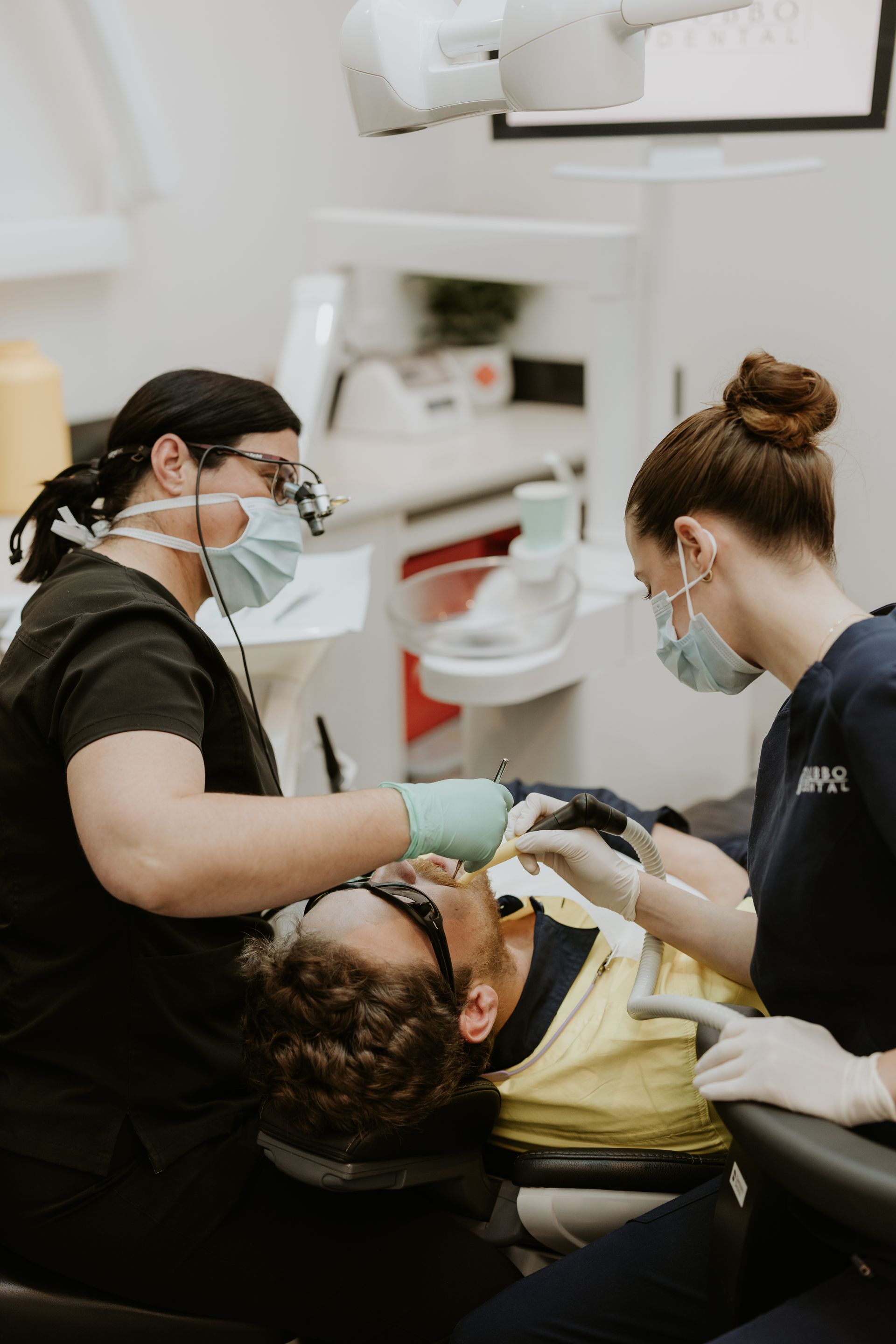 Dentist and Assistant Working on a Patient's Teeth in a Dental Office — Dubbo Dental in Dubbo, NSW