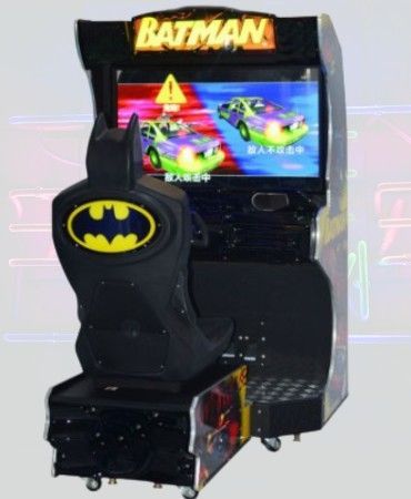 Batman-themed arcade game. A black cabinet with a seat shaped like Batman. A screen shows two cars racing.