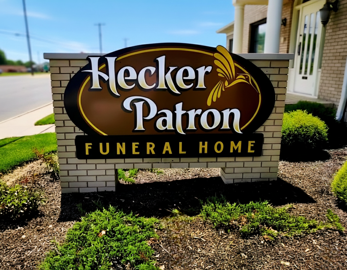 A sign for the hecker patron funeral home