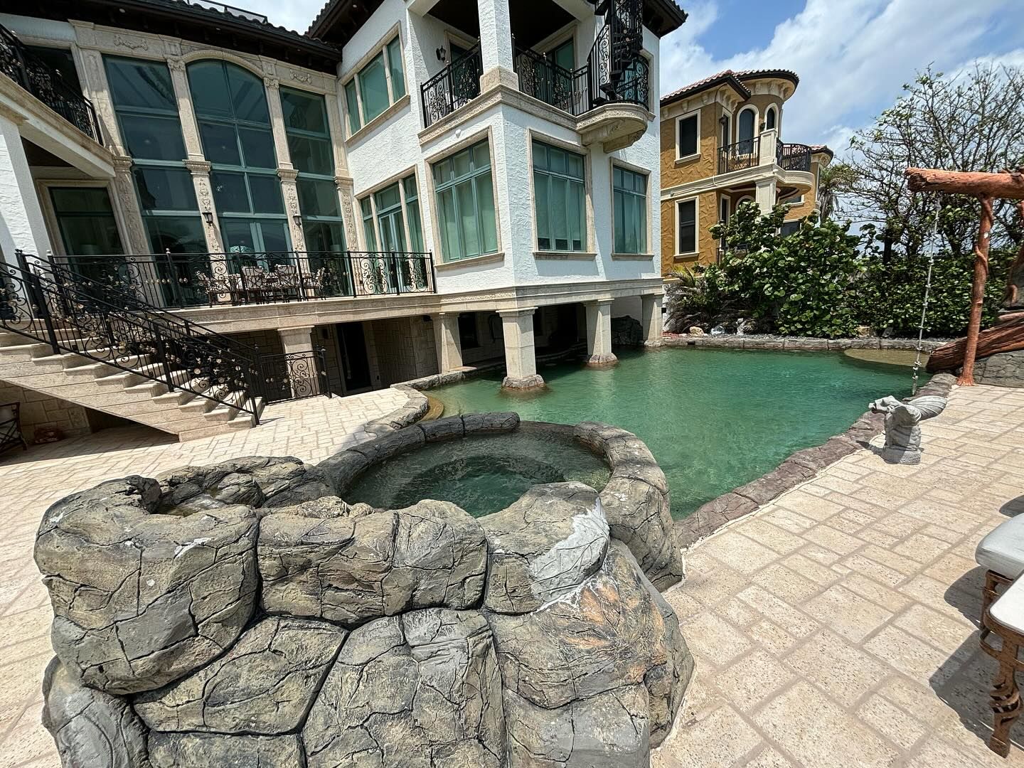 A large house with a swimming pool in front of it