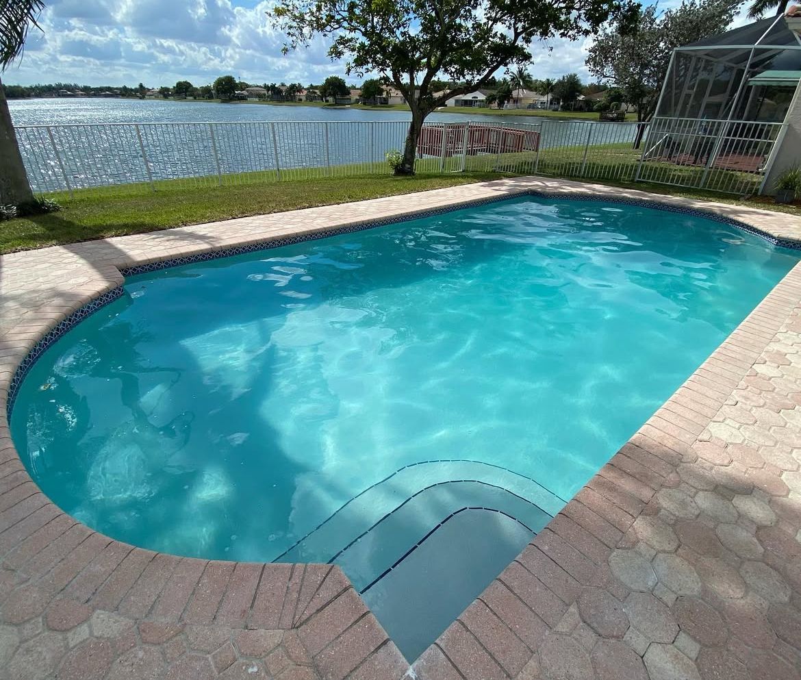 A large swimming pool with a view of a lake