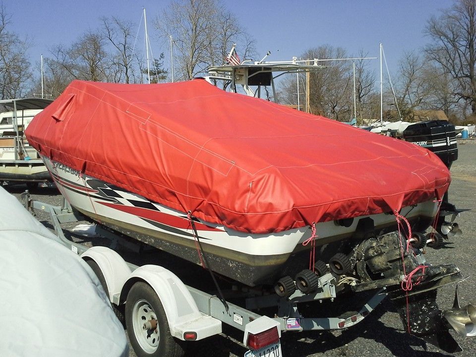 Red-covered speedboat on a trailer outdoors on a sunny day