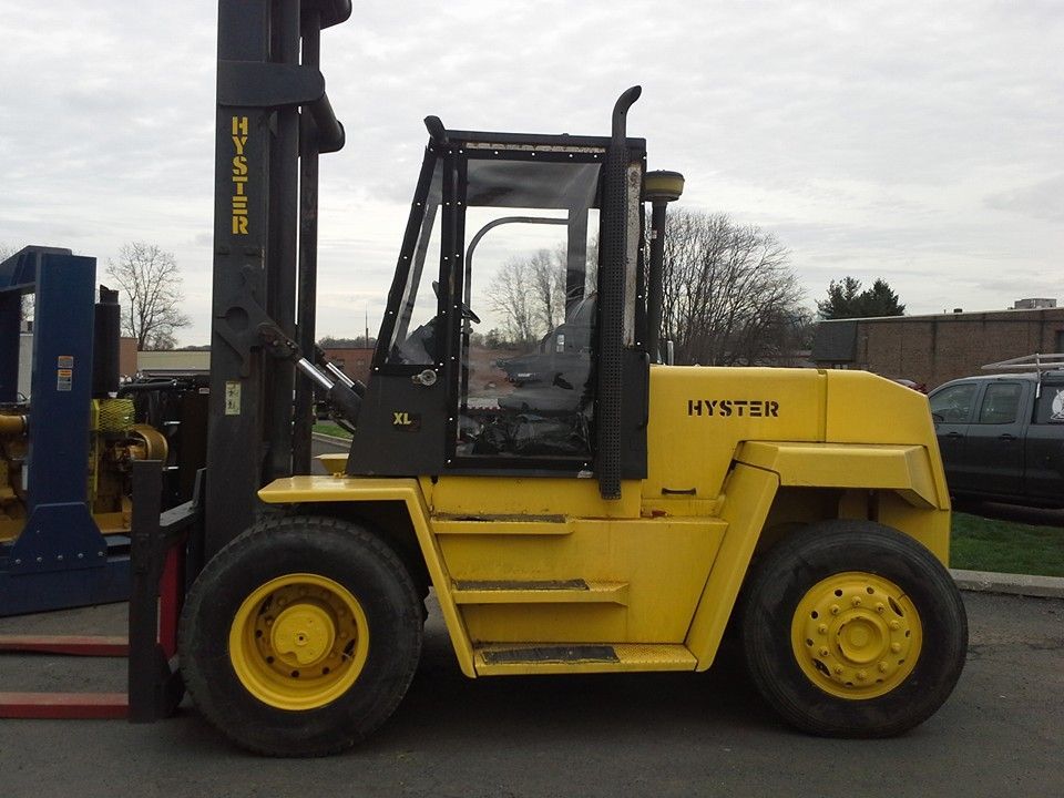 Yellow Hyundai forklift parked outdoors on a paved lot under a cloudy sky