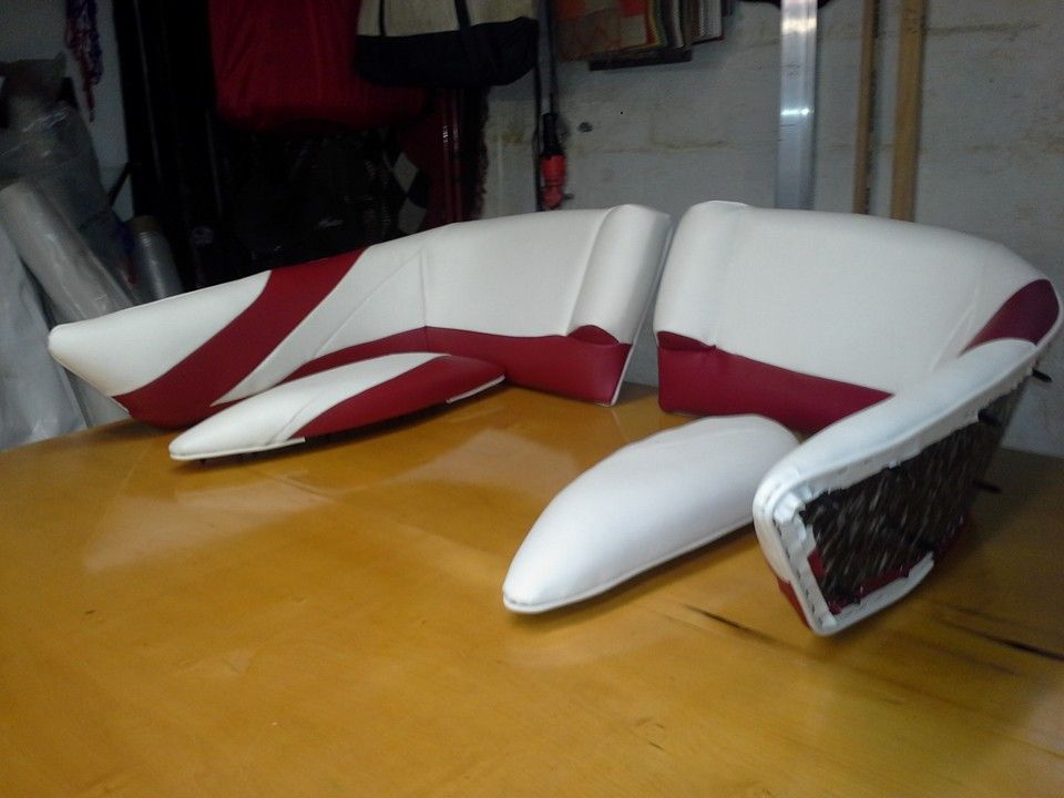 White and red foam lounge chairs on a wooden table in a workshop
