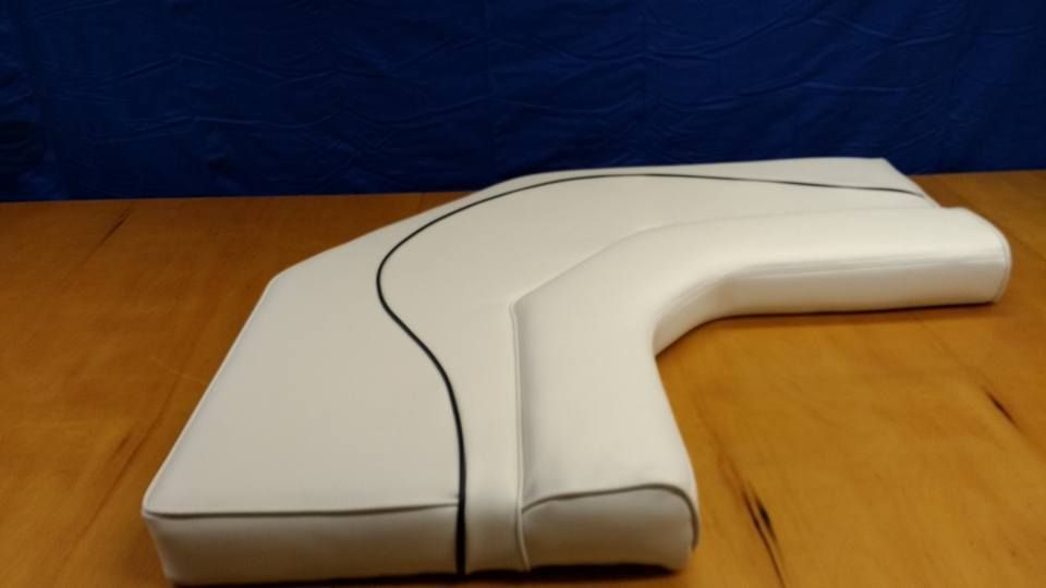 White plastic handheld device on a wooden surface, with a black cord trailing across it