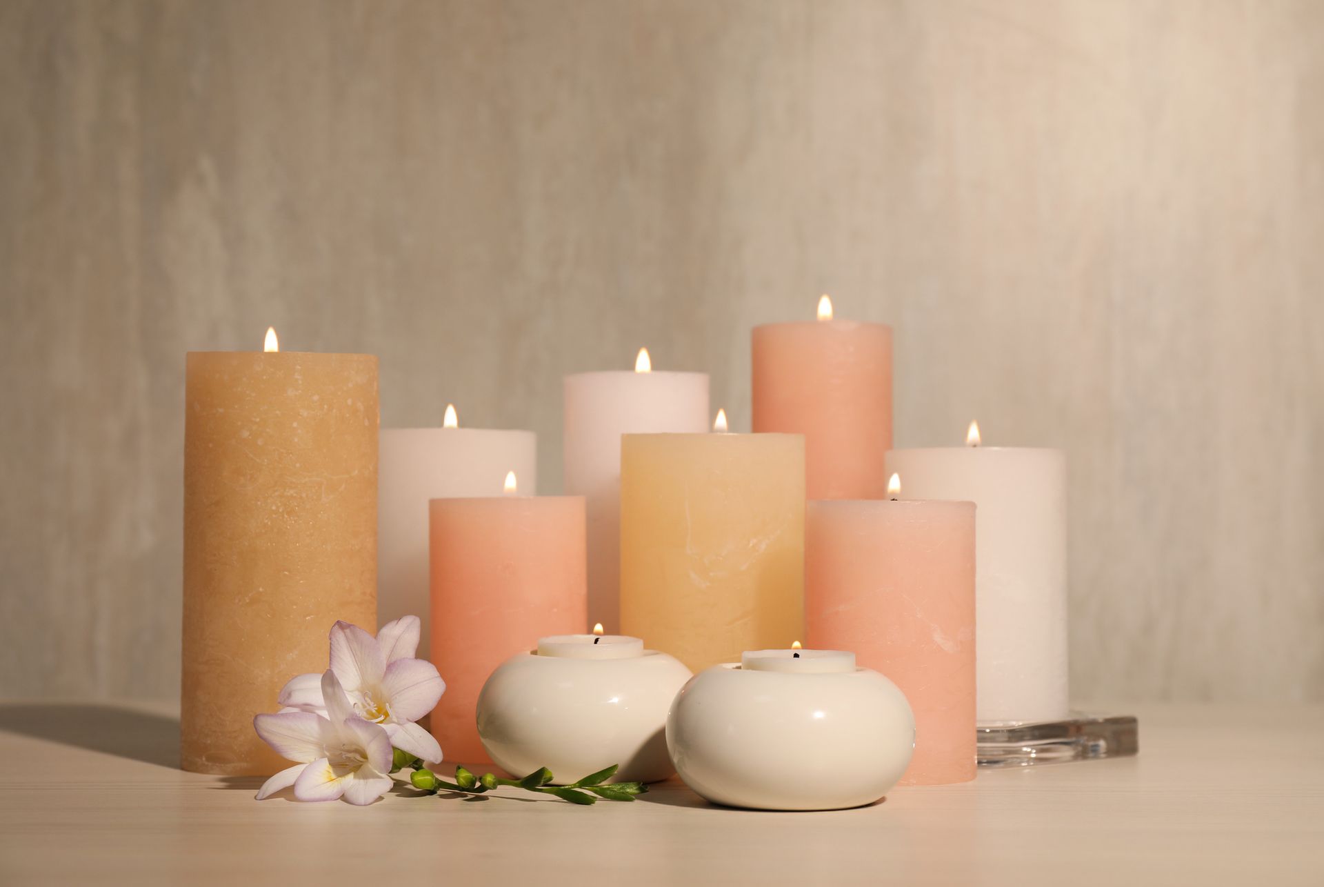 There are many different types of candles on the table.