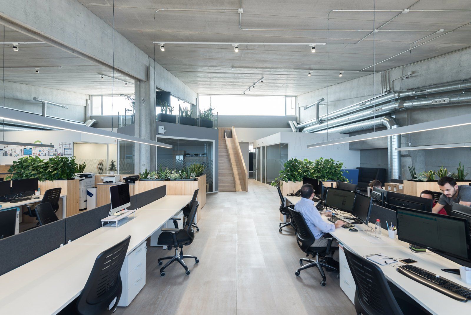 A man is sitting at a desk in an office.