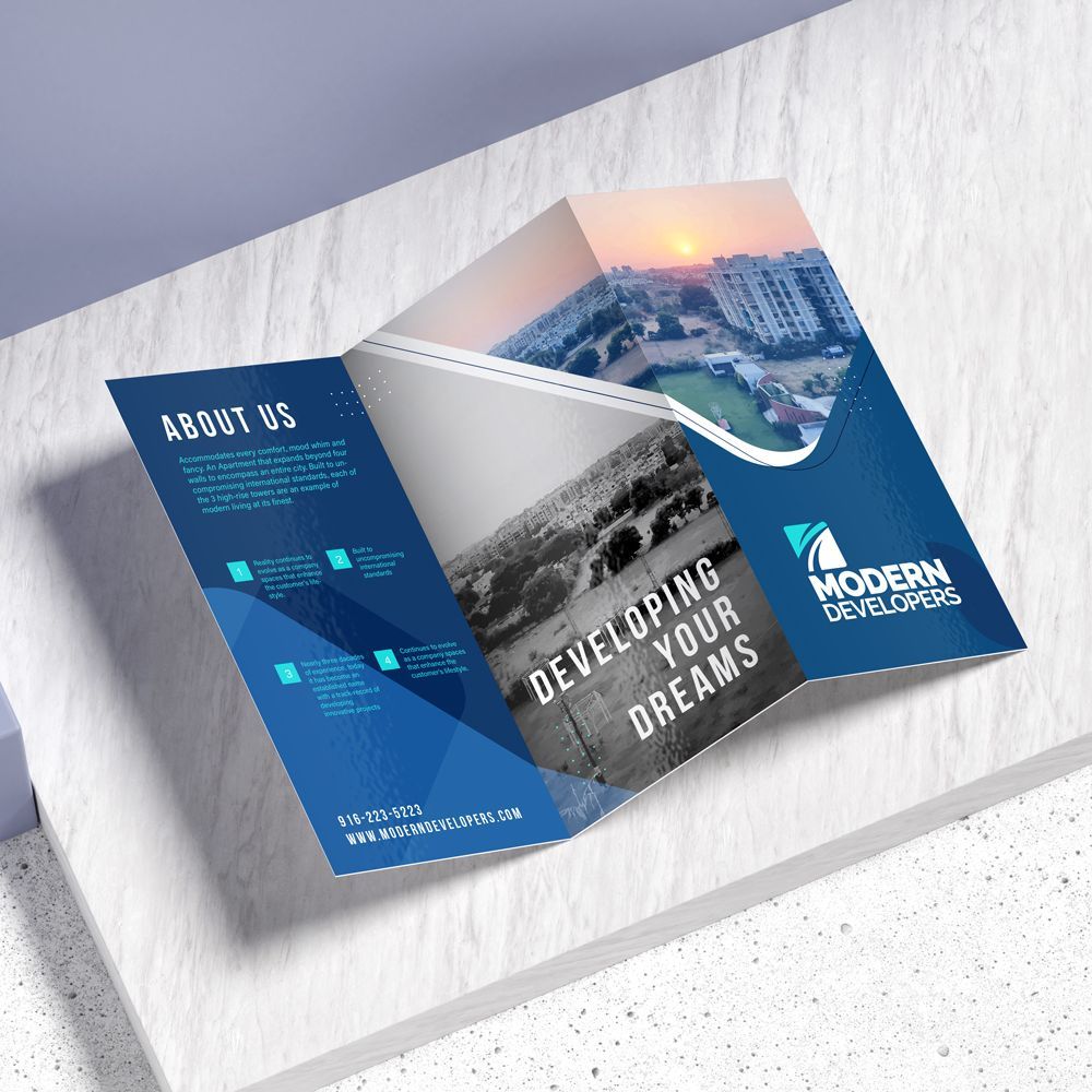 A brochure for modern developers is sitting on a wooden table. A brochure for modern developers is sitting on a wooden table.