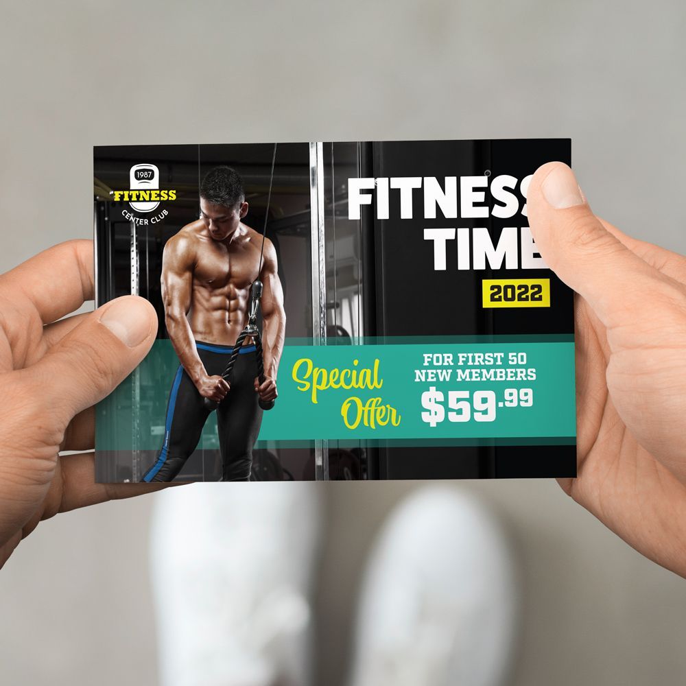 A person is holding a fitness time card in their hand. A person is holding a fitness time card in their hand.
