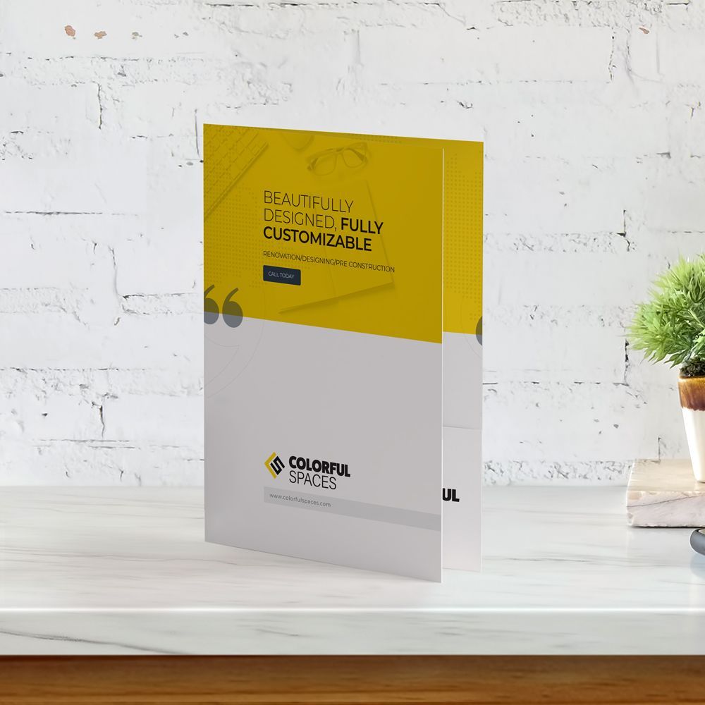 Presentation folder is sitting on a table next to a plant. Presentation folder is sitting on a table next to a plant.