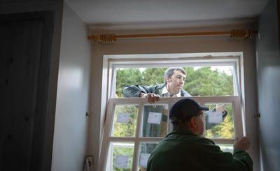 Two Men Installing The Window — St. Louis, MO — Edelen Door & Window Two Men Installing The Window — St. Louis, MO — Edelen Door & Window