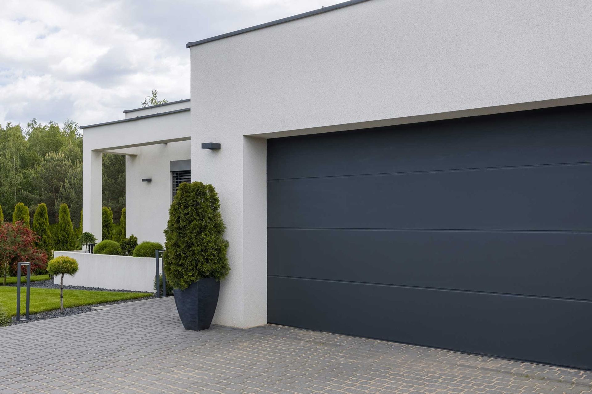 View of a modern garage door in an elegant suburban home, after a garage door installation service.