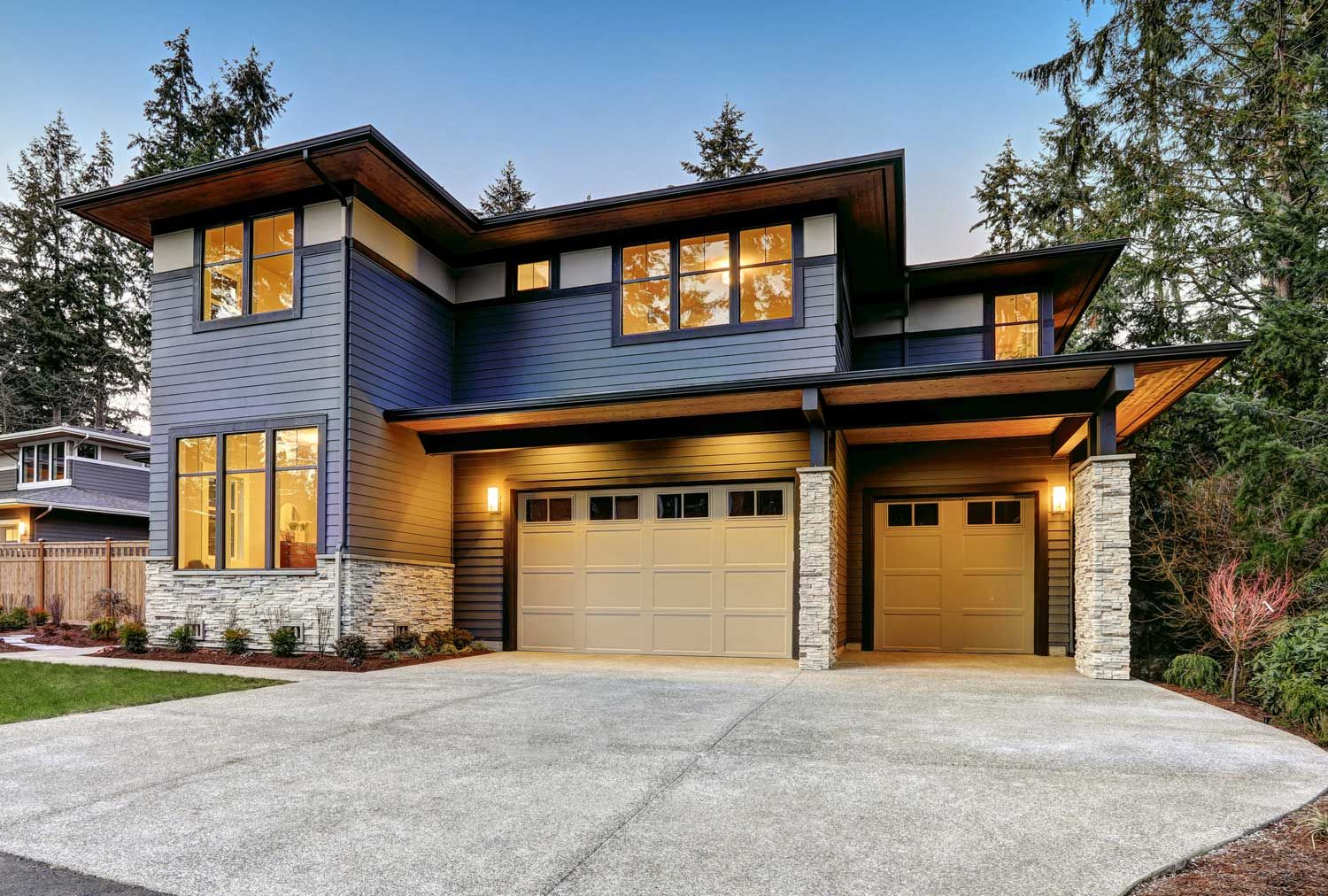 A large house with a garage and a driveway in front of it.
