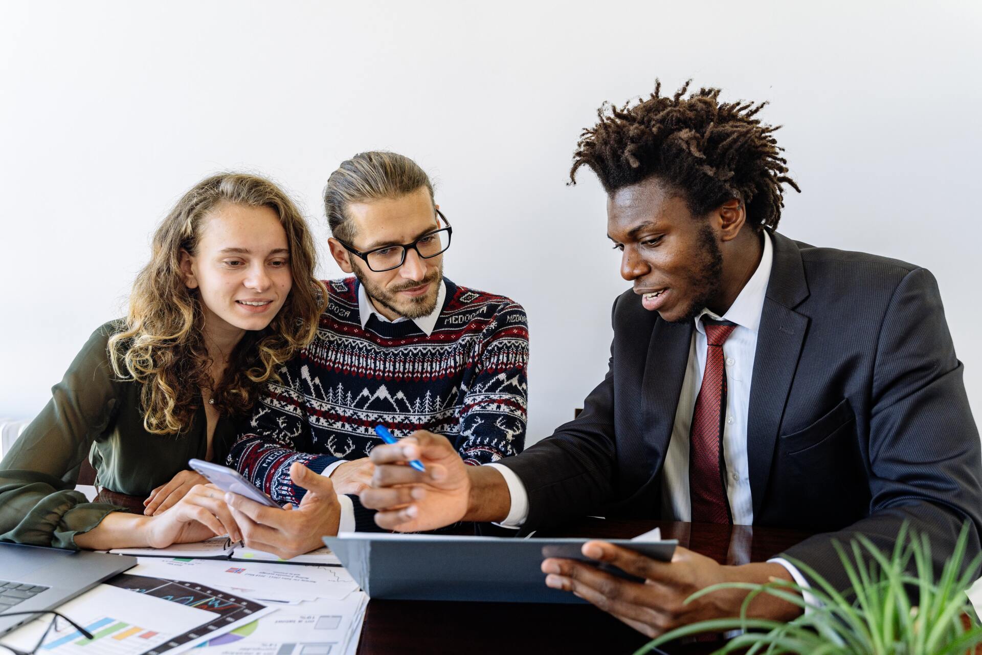 Couple looking at documents with mortgage broker rent to own team member
