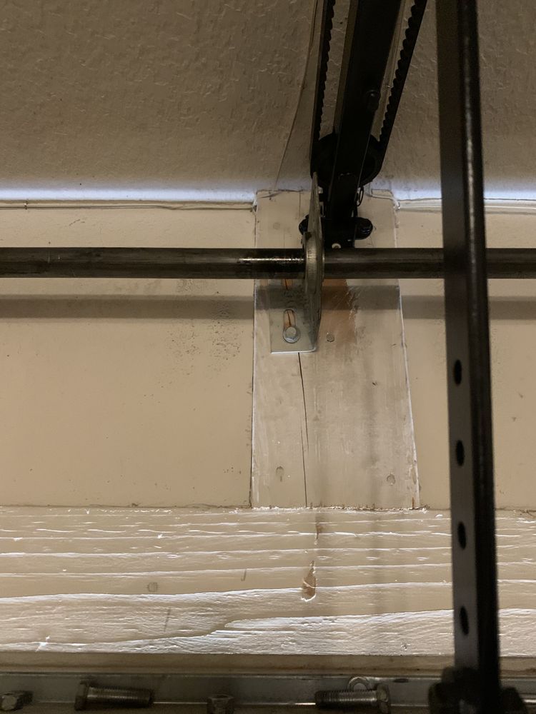 A close up of a garage door with a chain attached to it.