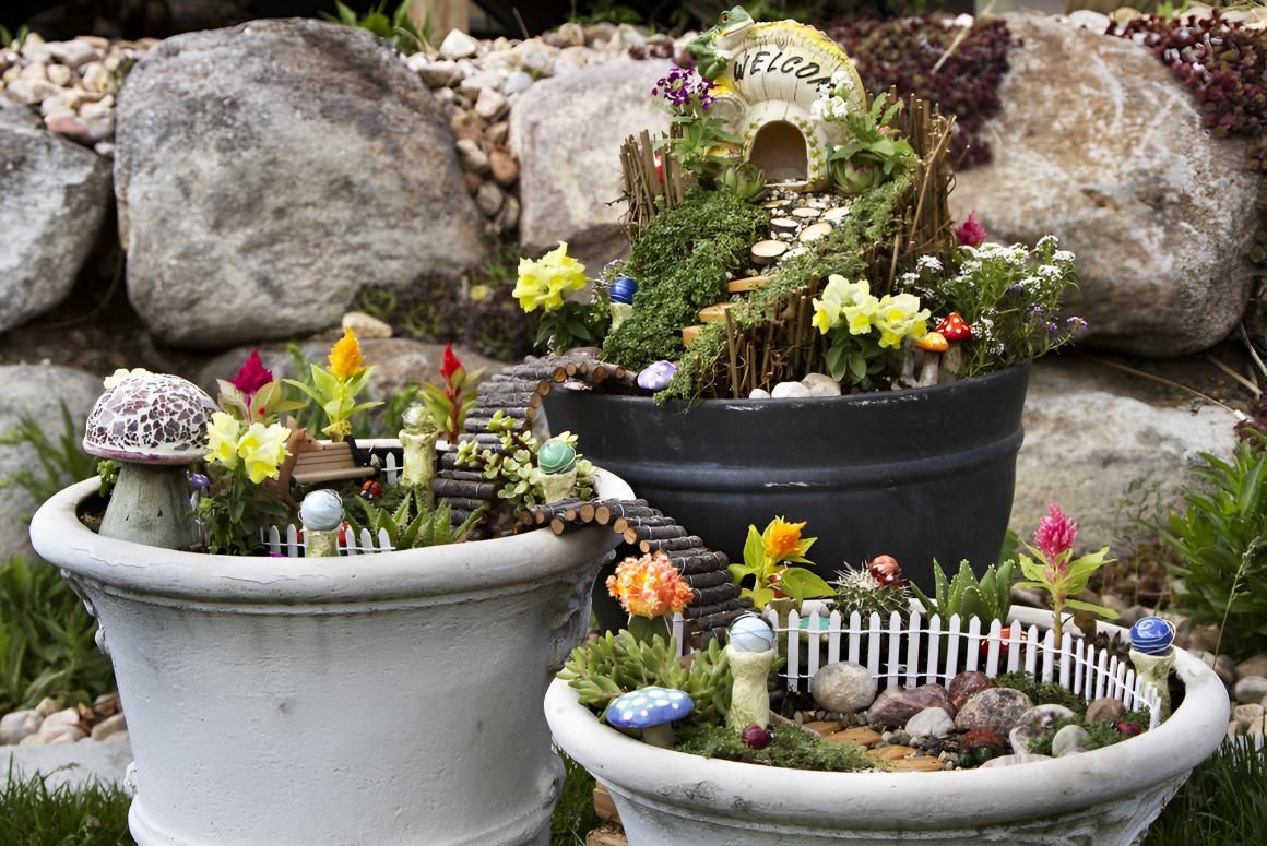 Two Pots Filled With Flowers and Fairy Figurines — CPR Exterior Cleaning in Bargara, QLD