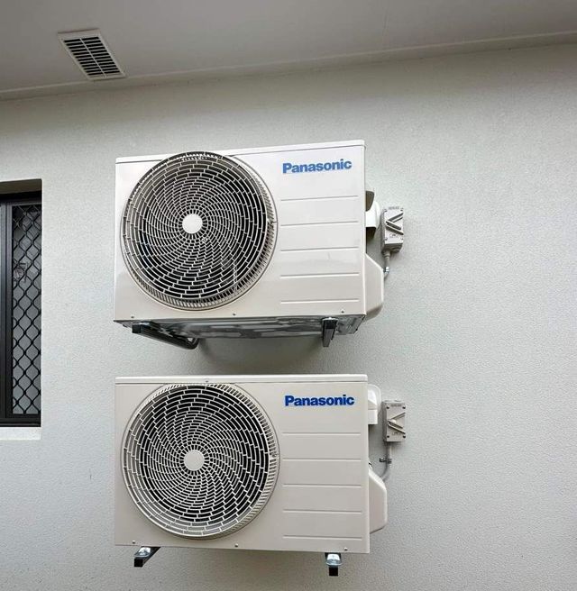 Two Air Conditioners Are Stacked on Top of Each Other — Eclipse Air Conditioning and Refrigeration in Trinity Beach, QLD