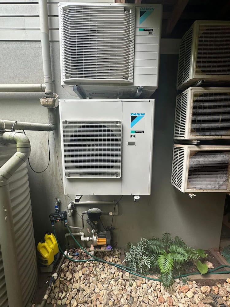Two Daikin Air Conditioning Units Mounted on a Gray Wall — Eclipse Air Conditioning and Refrigeration in Trinity Beach, QLD
