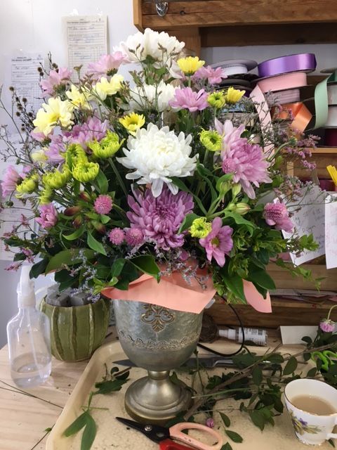 A Vase Filled with Flowers Is Sitting on A Table — Fiori With Love in Ingham, QLD