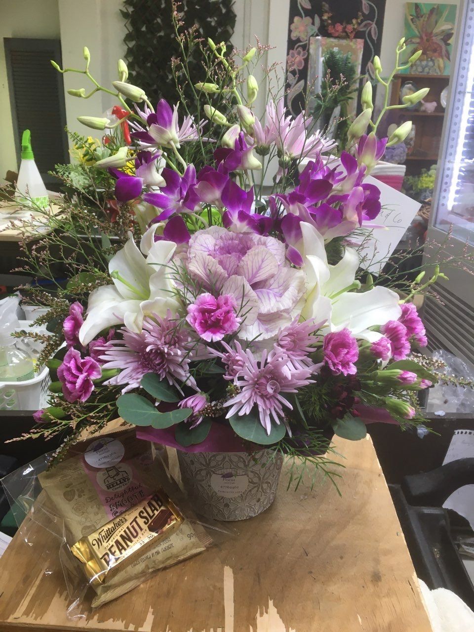 A Vase of Flowers Is Sitting on A Wooden Table — Fiori With Love in Ingham, QLD