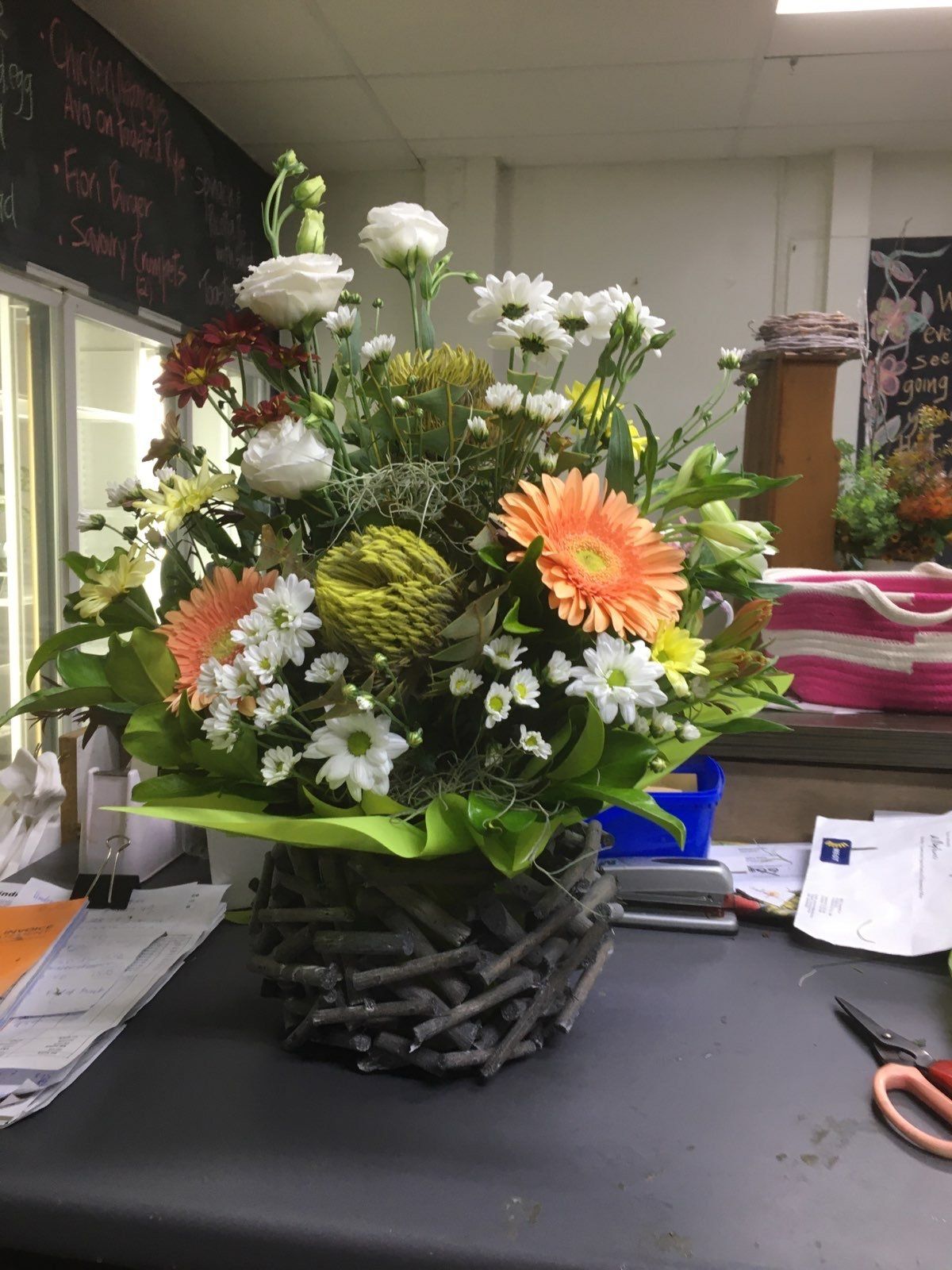 A Basket Filled with Flowers Is Sitting on A Table — Fiori With Love in Ingham, QLD