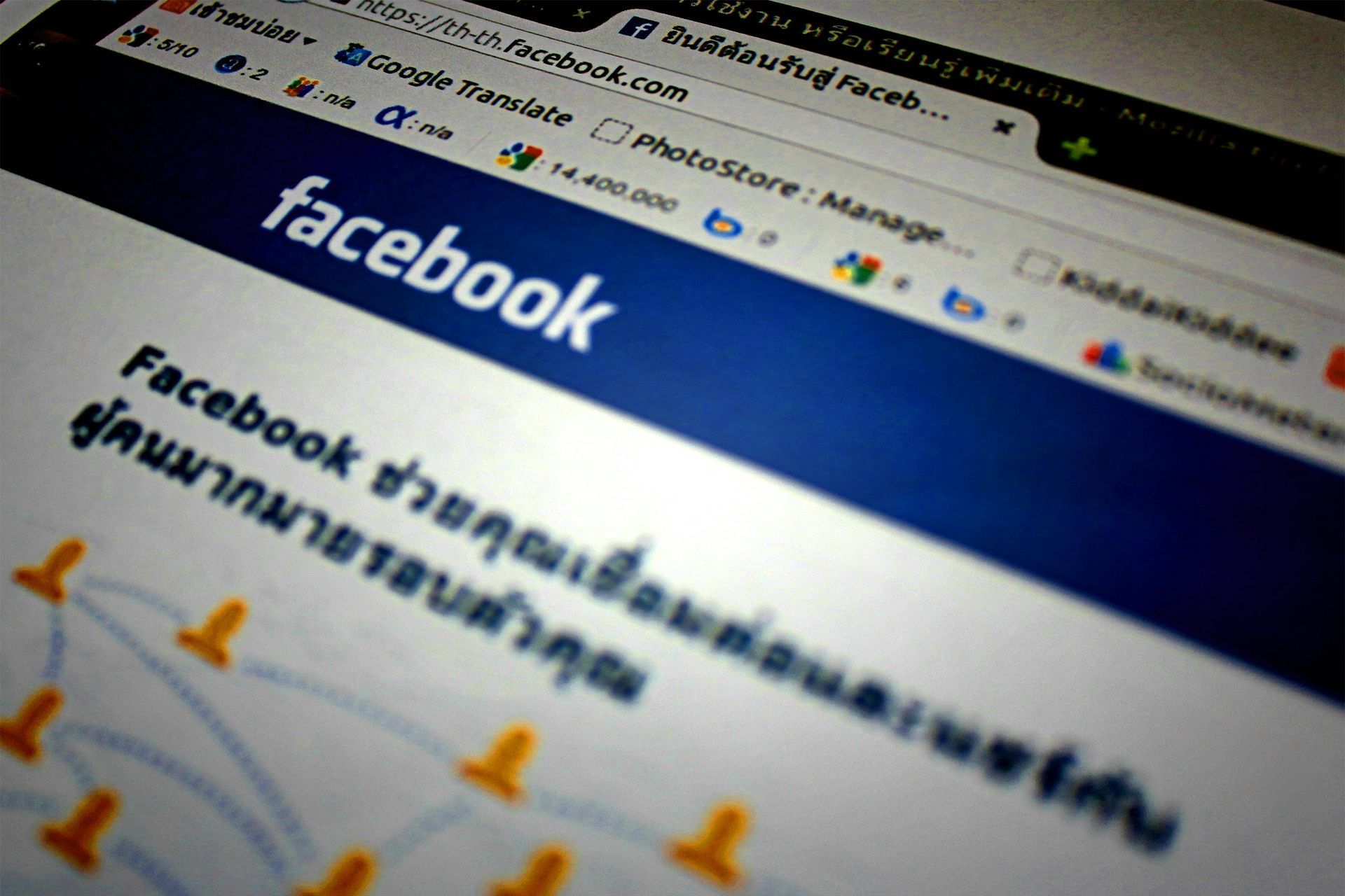Facebook website on a computer screen. Blue and white colors. Thai text is visible.
