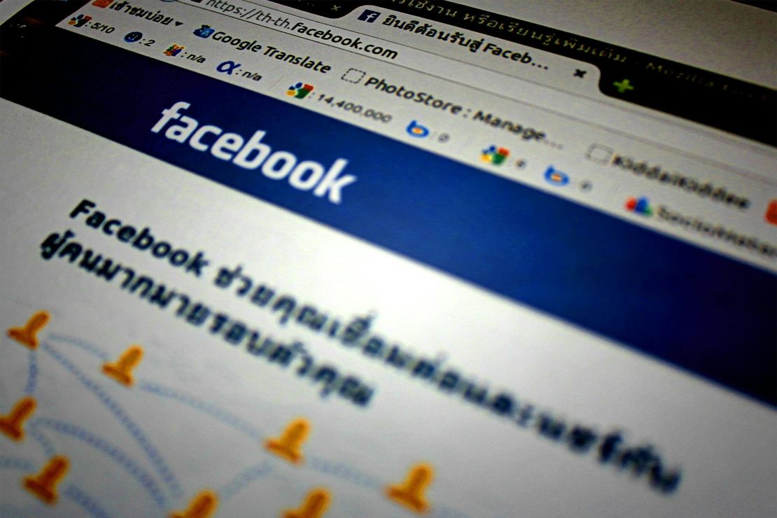 Facebook website on a computer screen. Blue and white colors. Thai text is visible.