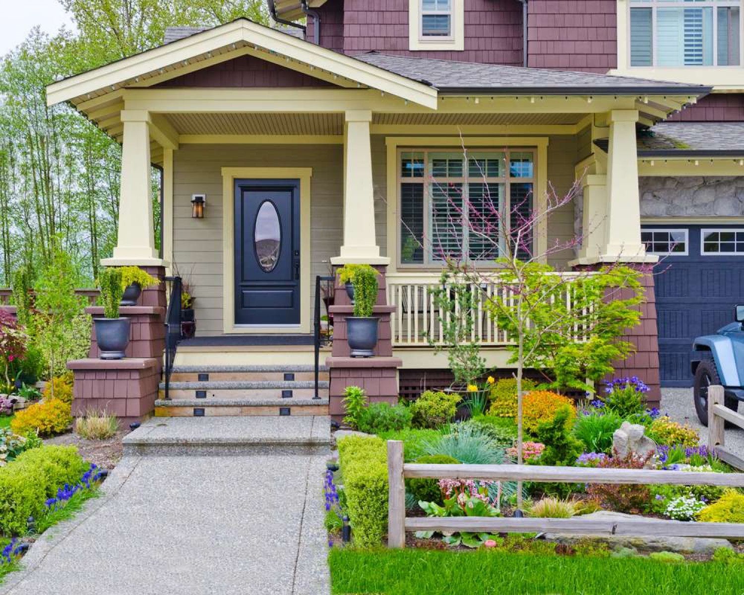 a large house with a large porch and a car parked in front of it .