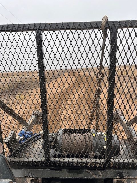 A chain link fence with a winch attached to it
