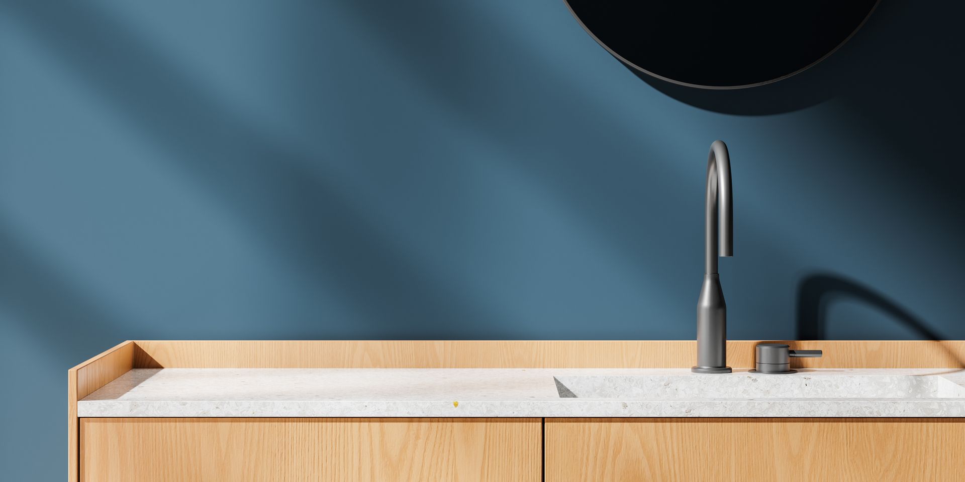 Modern kitchen sink with wooden countertop, chrome faucet, and blue wall background