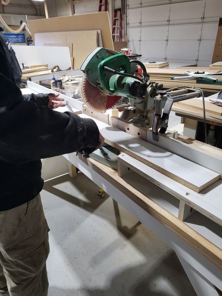 Guy using a saw to cut a board